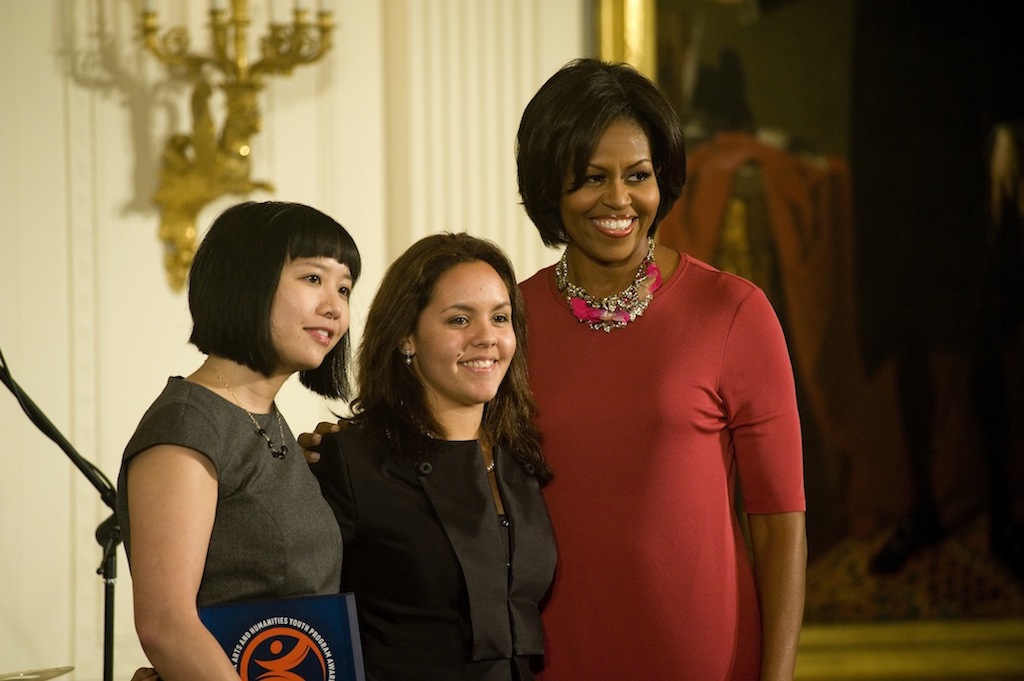 Representatives of WritersCorps, an Asian woman and a Latina teen, with First Lady Michelle Obama.